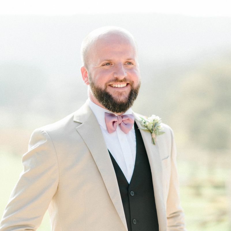 Groom in Black Suit with Beige Blazer and Pink Bow Tie