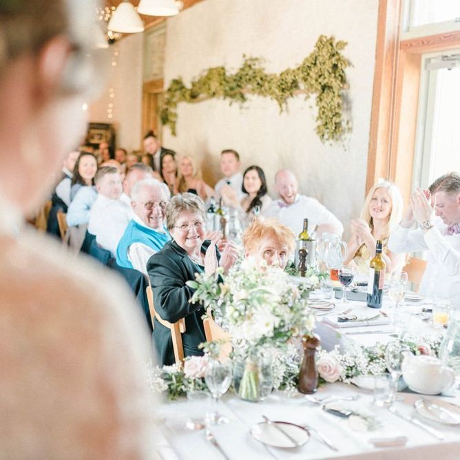 Wedding Guests Clapping at the Bride and Groom Enter The Wedding Reception