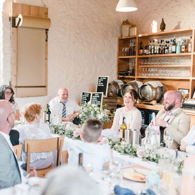 Bride and Groom Laughing During Wedding Reception Speeches