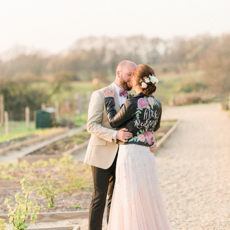 Groom Embracing His Bride in a Handpainted Leather Jacket