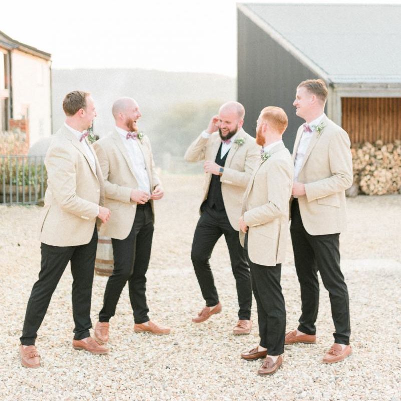 Groomsmen in Black Suits with Beige Jackets and Bow Ties