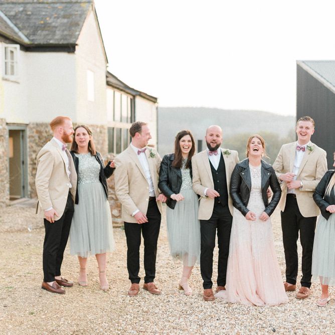 Wedding Party Portrait with Groomsmen in Beige Blazers and Bridesmaids in Leather Jackets