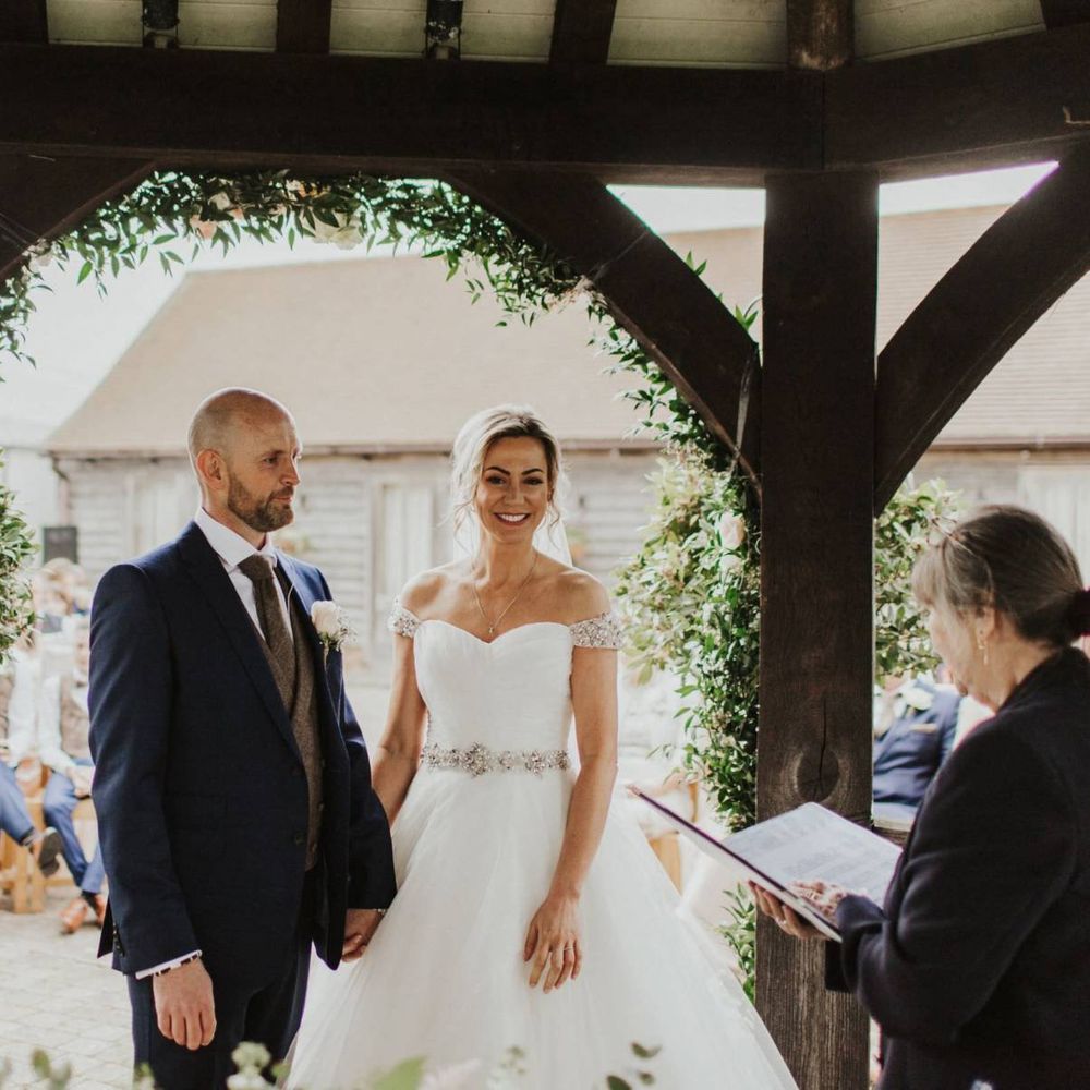 Bride and groom tie the knot at rustic ceremony with floral decor