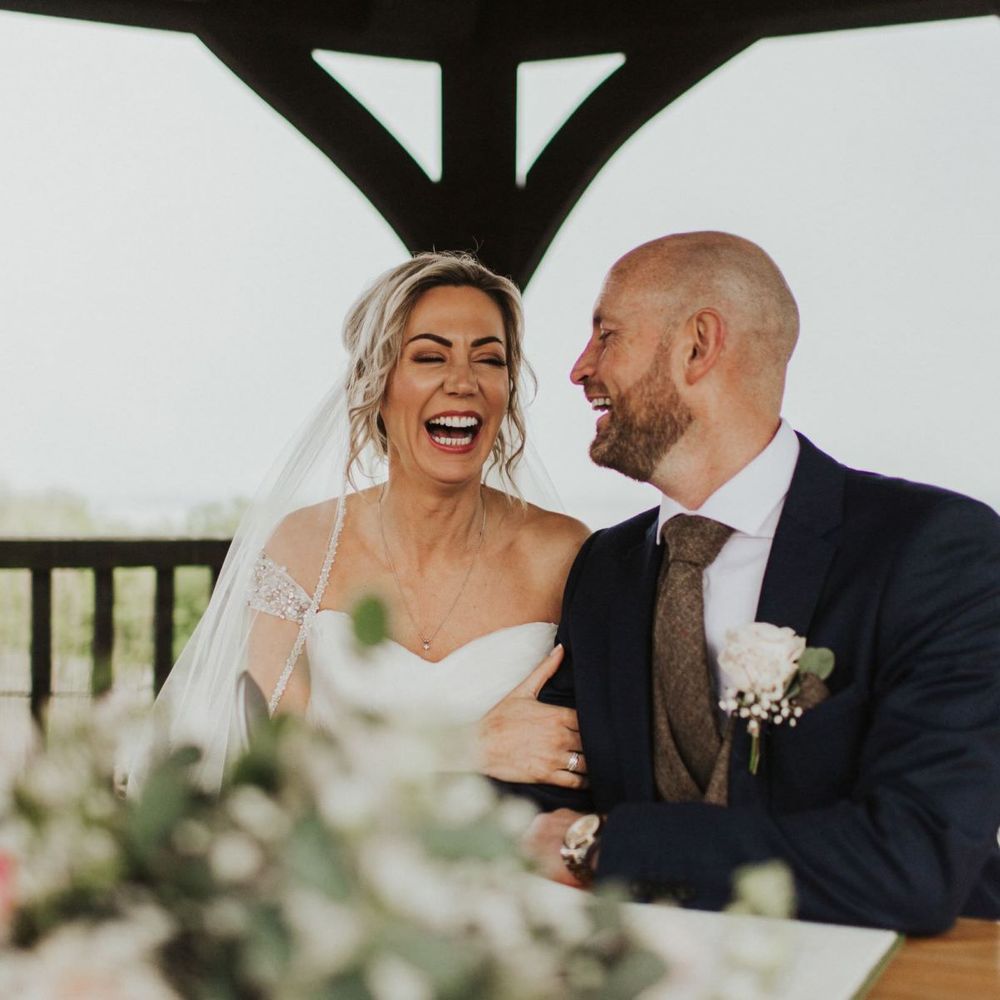 Bride and groom tie the knot at rustic ceremony with floral decor