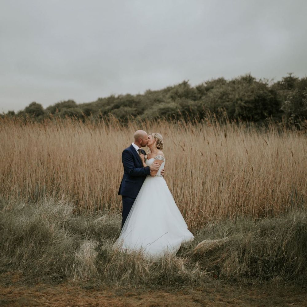 Bride and groom steal a moment at The Ferry House Inn for outdoor summer wedding