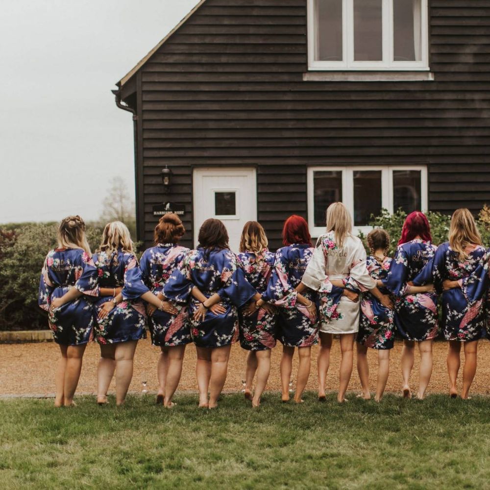 Bride and her thirteen bridesmaids wearing matching kimonos