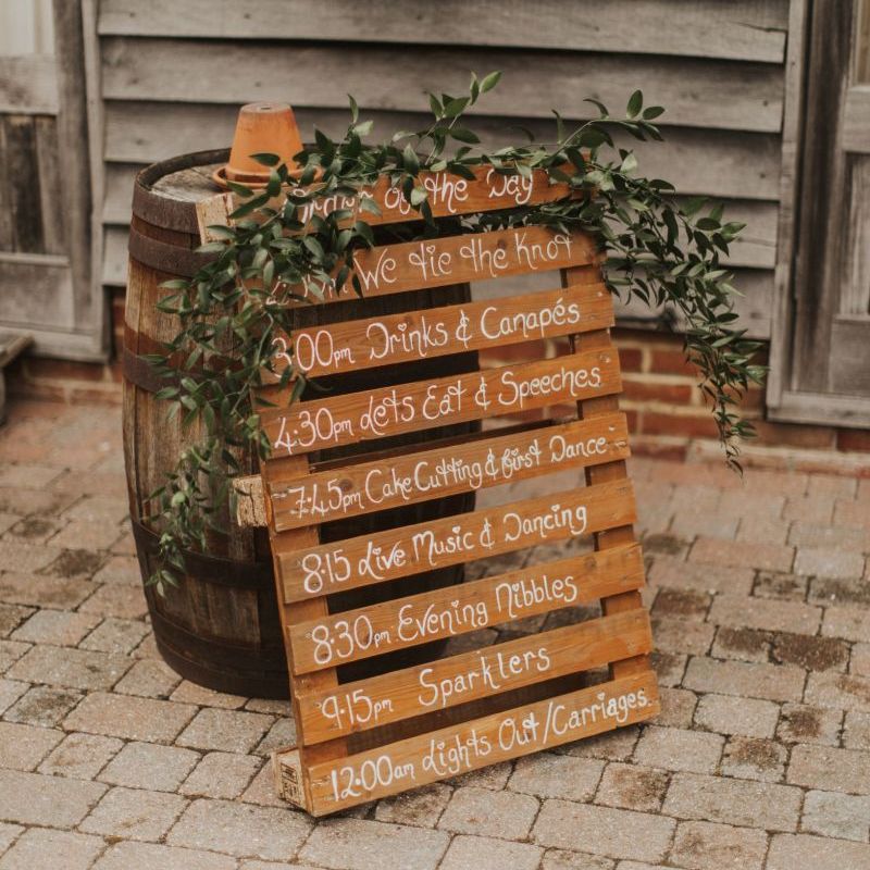 Pallet wedding sign with rustic foliage decor at The Ferry House Inn reception