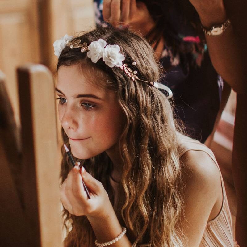 Bridesmaid wearing floral hair crown and nude dress for rustic wedding at The Ferry House Inn
