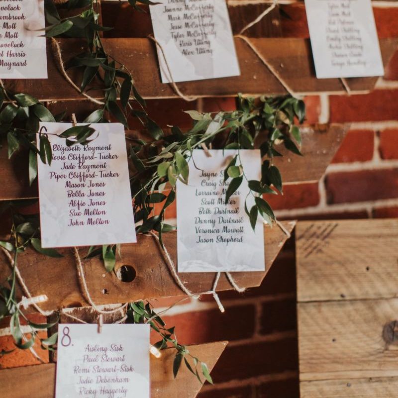 Heart shaped pallet table plan with foliage decor for rustic wedding