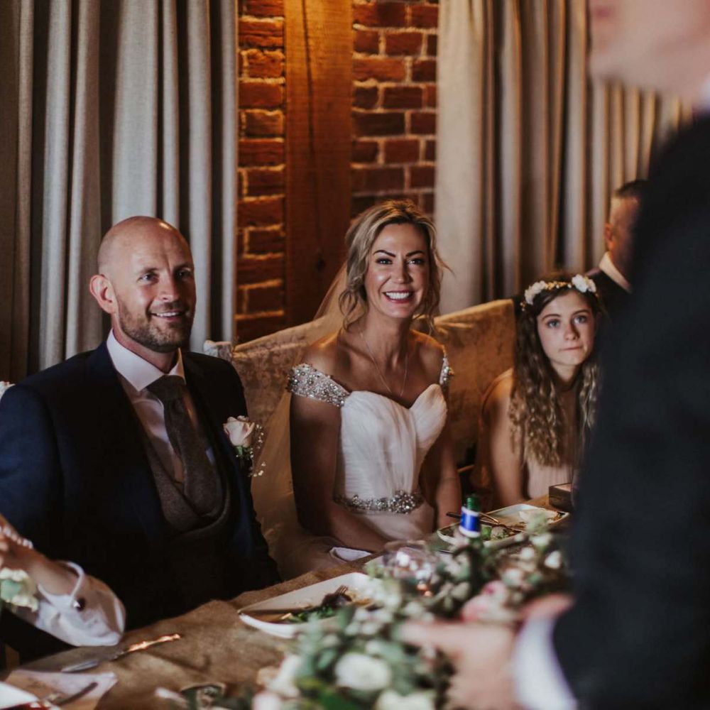 Bride and groom at The Ferry House Inn reception with rustic styling and floral decor