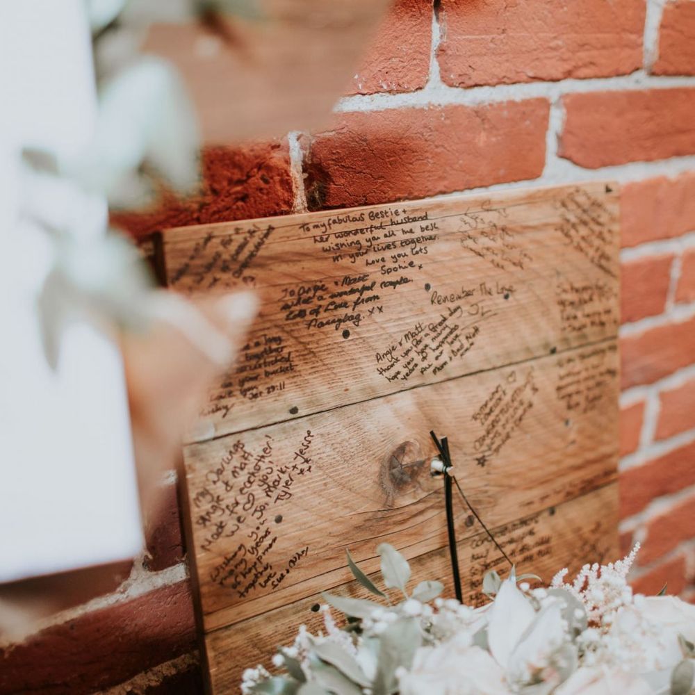 Homemade wooden clock with personal messages at rustic wedding