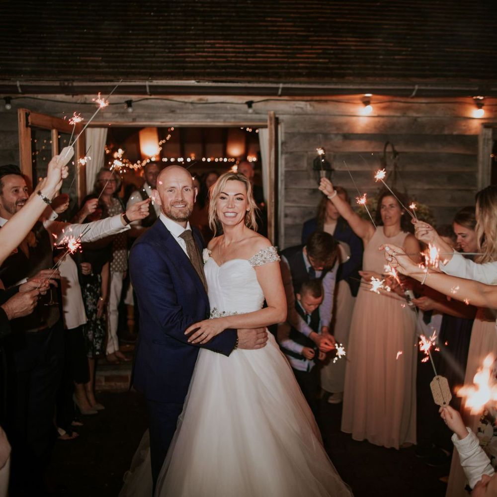 Sparkler exit for bride and groom with bridesmaids wearing nude dresses