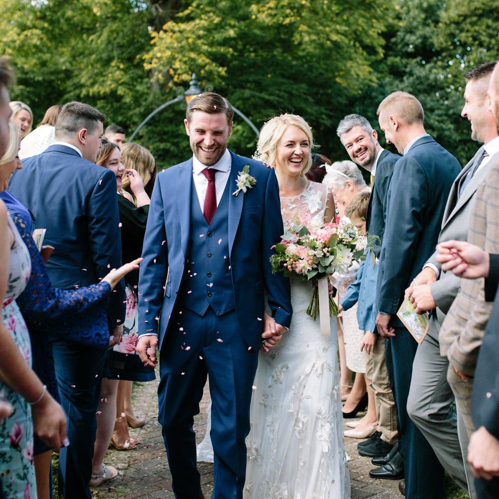Confetti Moment | Bride in Claire Pettibone Whitney Bridal Gown with Cape | Groom in French Connection Navy Suit | DIY Country Wedding at Warborne Farm, Lymington | Camilla Arnhold Photography