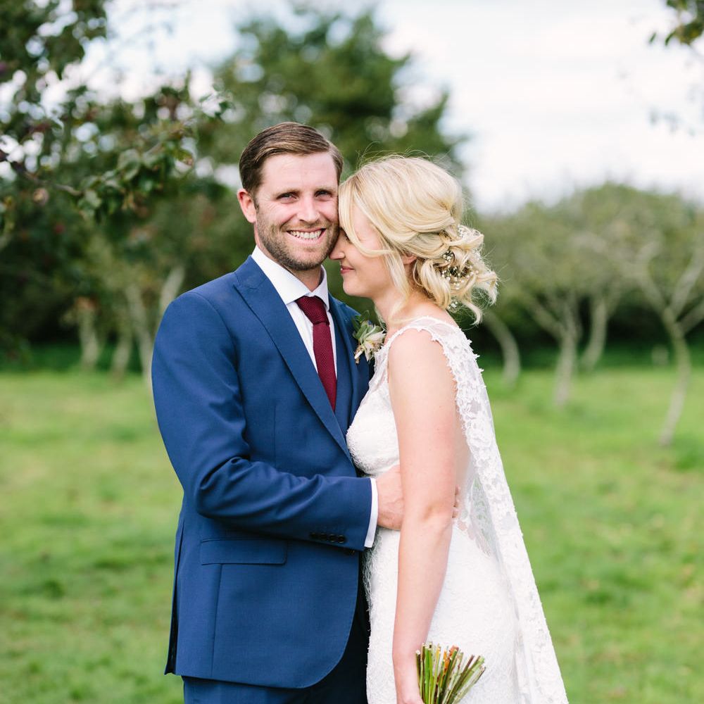 Bride in Claire Pettibone Whitney Bridal Gown with Cape | Groom in French Connection Navy Suit | DIY Country Wedding at Warborne Farm, Lymington | Camilla Arnhold Photography