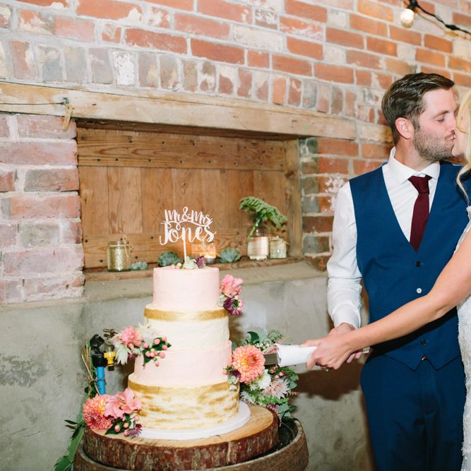 Cutting the Cake | Bride in Claire Pettibone Whitney Bridal Gown with Cape | Groom in French Connection Navy Suit | DIY Country Wedding at Warborne Farm, Lymington | Camilla Arnhold Photography