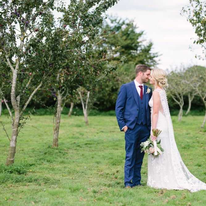 Bride in Claire Pettibone Whitney Bridal Gown with Cape | Groom in French Connection Navy Suit | DIY Country Wedding at Warborne Farm, Lymington | Camilla Arnhold Photography