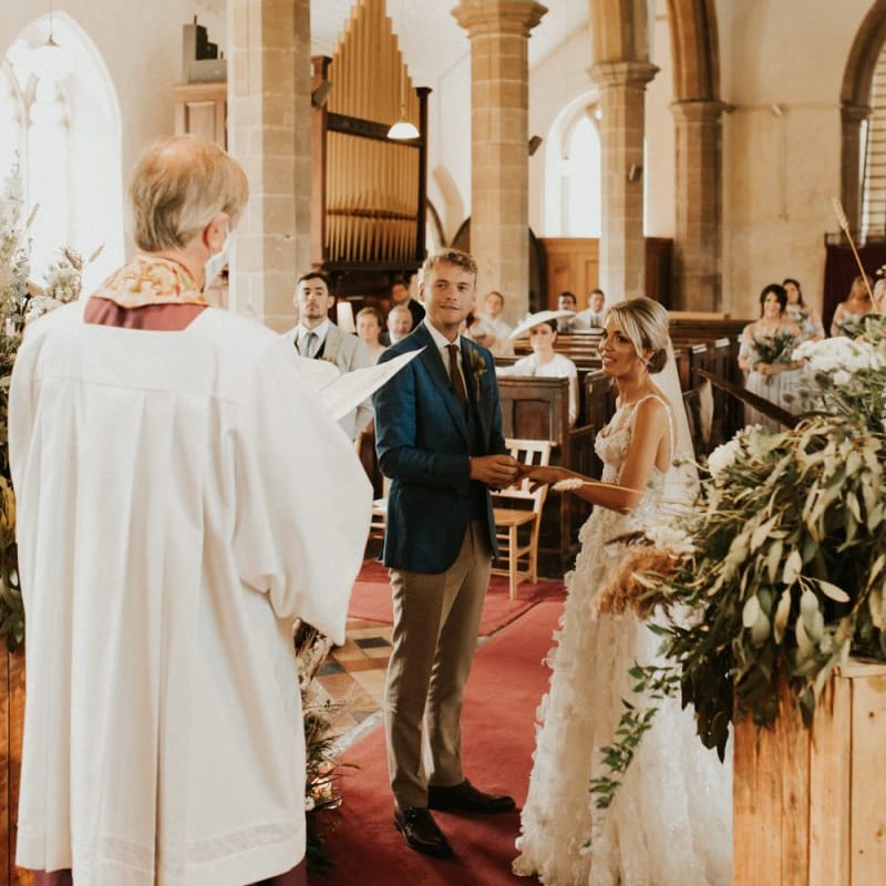 Bride and groom exchanging vows at their August 2020 wedding