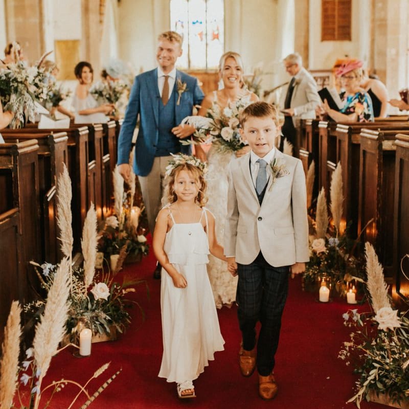Flower girl and page boy walking down the aisle
