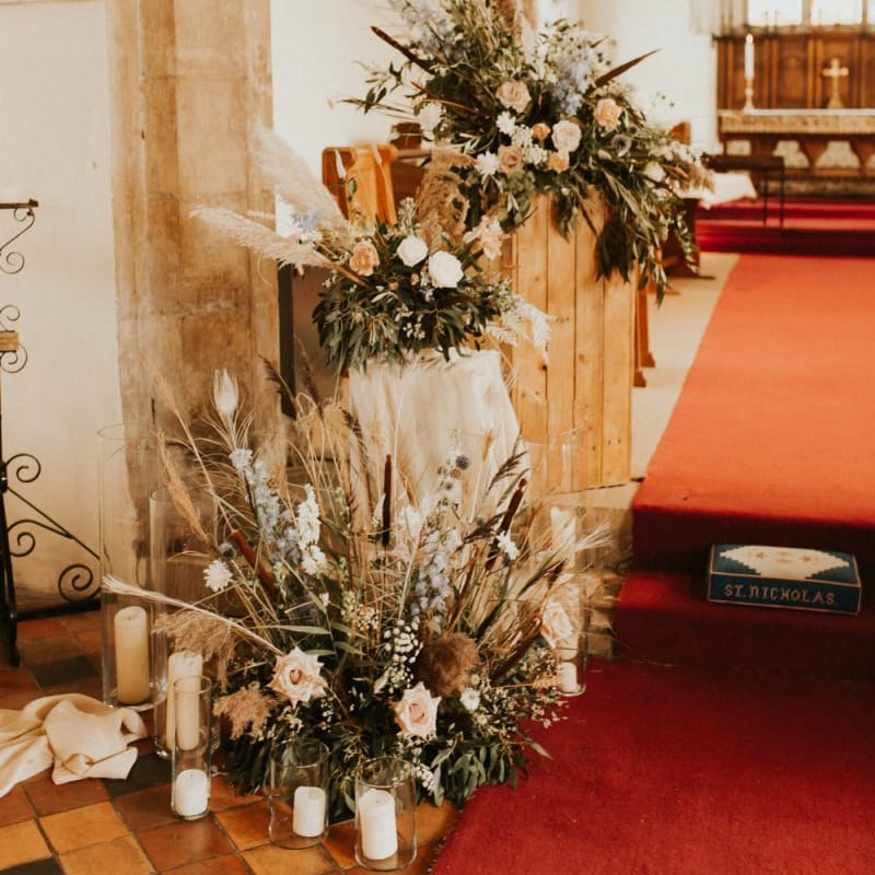 Neutral dried flower and grass floral arrangement in the church