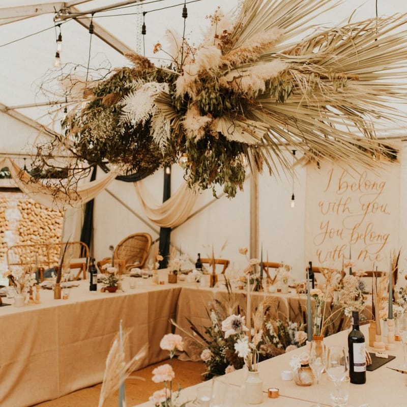 Marquee wedding reception with dried flower installation