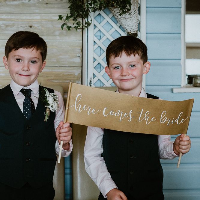 Page Boys with Here Comes The Bride Sign | Lusty Glaze Beach Wedding Newquay Cornwall | Alexa Poppe Photography