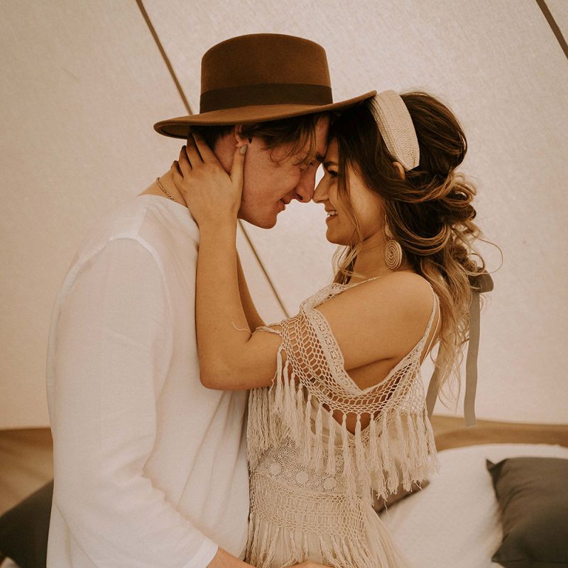 Boho Couple Embracing in a Bell Tent