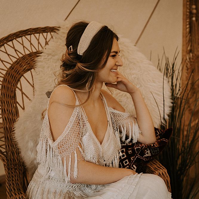 Boho Bride in Fringe Wedding Dress Sitting on a Wicker Chair
