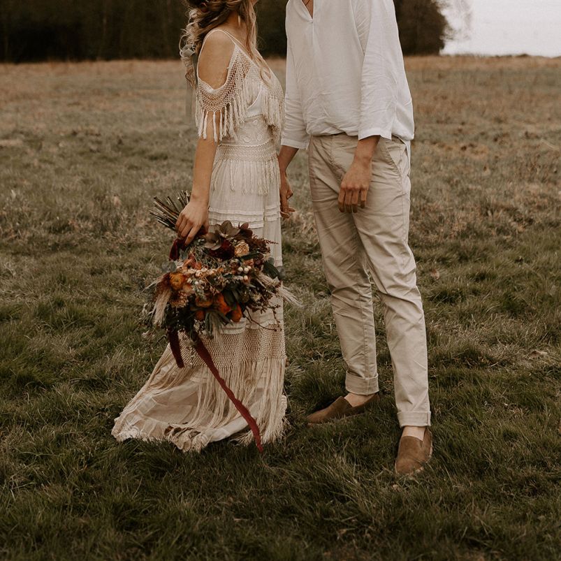 Boho Bride and Groom Kissing in a Field