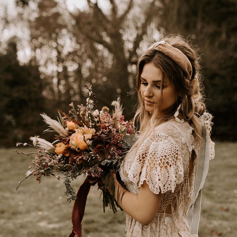 Boho Bride in Lace Wedding Dress Holding a Boho Wedding Bouquet