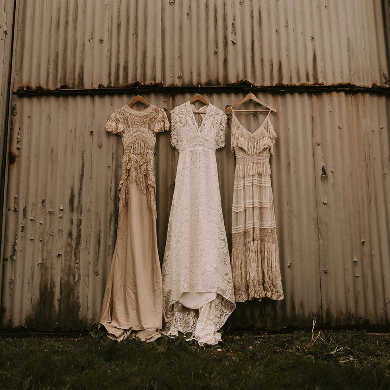 Three Boho Wedding Dresses hanging Up with Lace and Fringe Detail