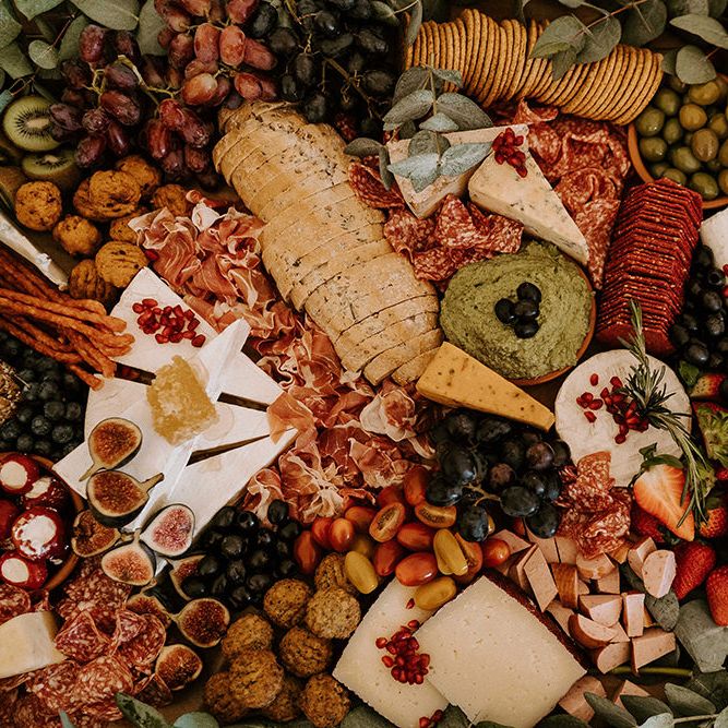 Grazing Board with a Mixture of Bread, Cheese, Crackers, Fruits and Vegetables