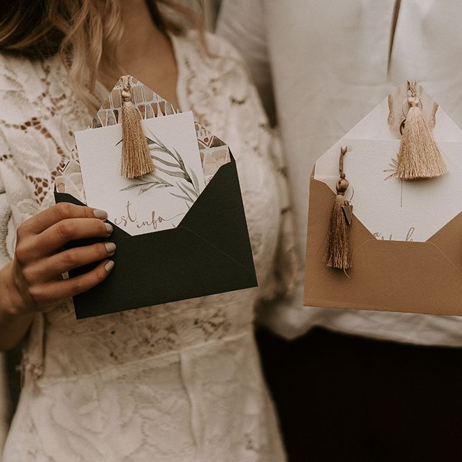 Bride and Groom Holding the Wedding Invitation with Tassel Detail