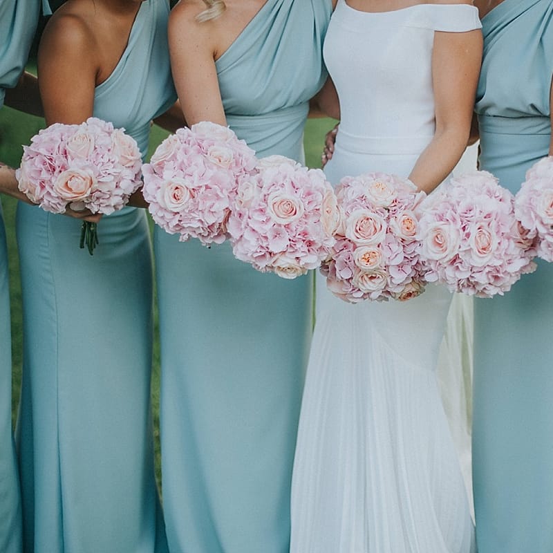 Bridal Party Pink Rose Bouquets | Bridesmaids in Mint Green One Shoulder Vivie Grace by Jayde Spicer | Bride in Suzanne Neville Bardot Nouveau Wedding Dress | Pastel Pink &amp; Mint Green Wedding at Granary Estates Suffolk | Julia &amp; You Photography