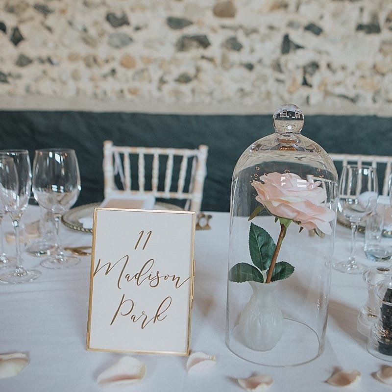 Gold Foil Wedding Stationery Table Name Card | Single Rose Flower Stem Under a Cloche | Sleeping Beauty Inspired Centrepiece | Pastel Pink &amp; Mint Green Wedding at Granary Estates Suffolk | Julia &amp; You Photography