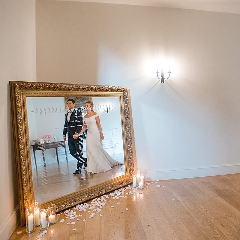Giant Mirror Table Plan | Bride in Suzanne Neville Bardot Nouveau Wedding Dress | Groom in Black Tie | Pastel Pink &amp; Mint Green Wedding at Granary Estates Suffolk | Julia &amp; You Photography