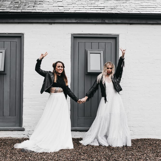 Same sex brides in a back and white dress, separates and leather jackets