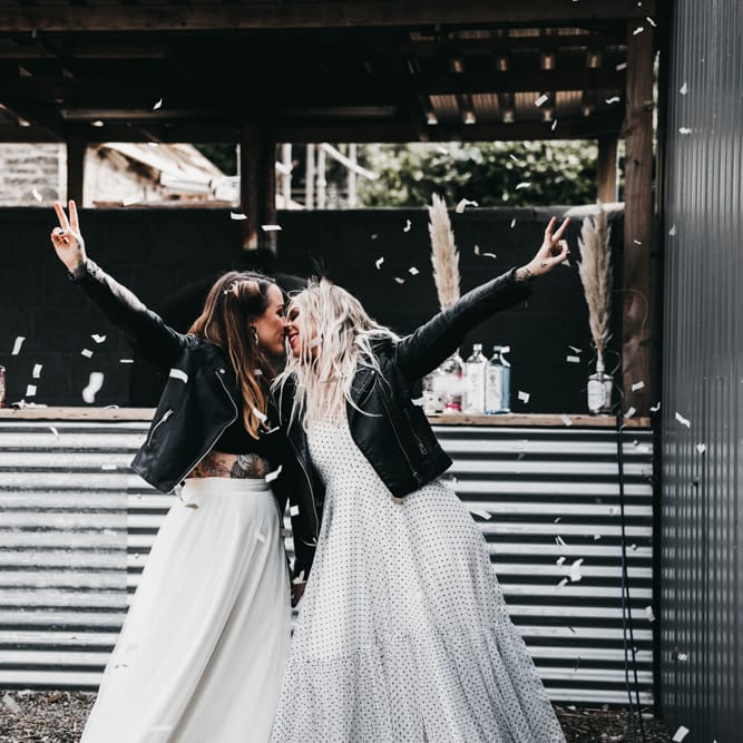 Rock n roll brides kissing at The Drovers wedding venue