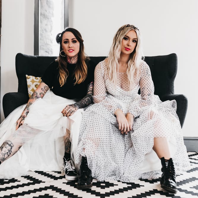 Same sex couple in polka dot black and white wedding dress and bridal separates