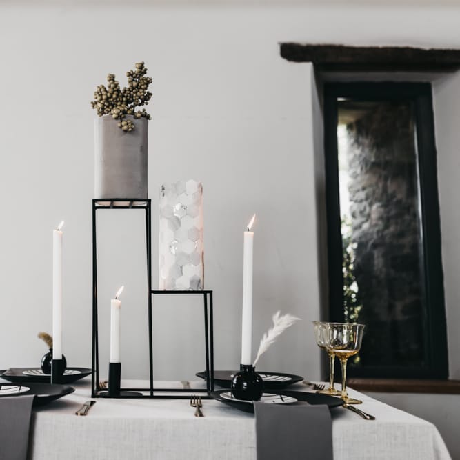 Intimate black and white table decor with wedding cake centrepiece