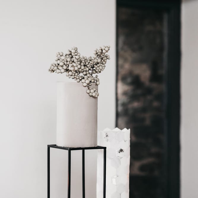 Contemporary grey wedding cake with berry topper