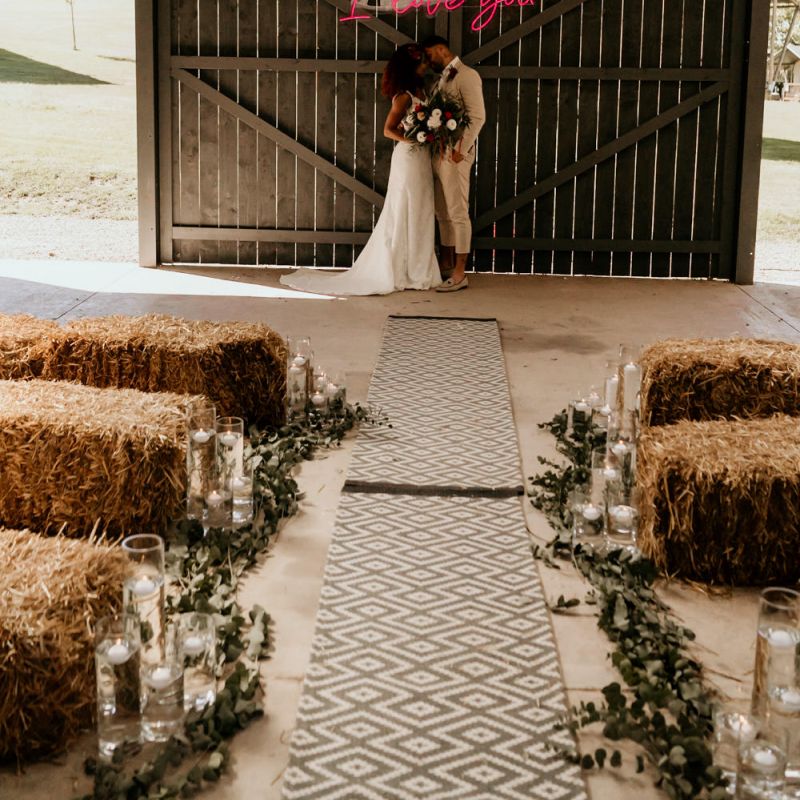 Black Bride with Afro Hair in a Lace Wedding Dress and Groom in Blazer and Loafers Standing at the Wedding Ceremony Altar