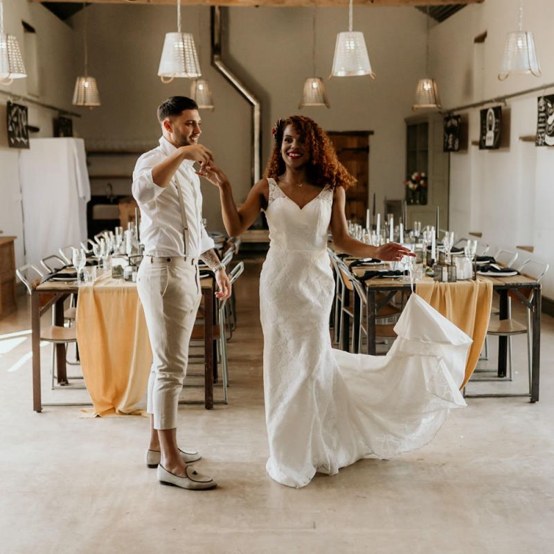 Black Bride in Lace Wedding Dress Being Twirled by Her Groom in  Skinny Trouser, White Shirt &amp; Loafers