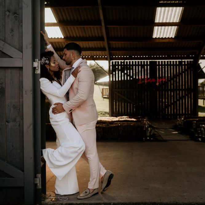 Black Bride with Afro Hair and Cheek Highlighter and Groom in Pink Suit and Floral Tie