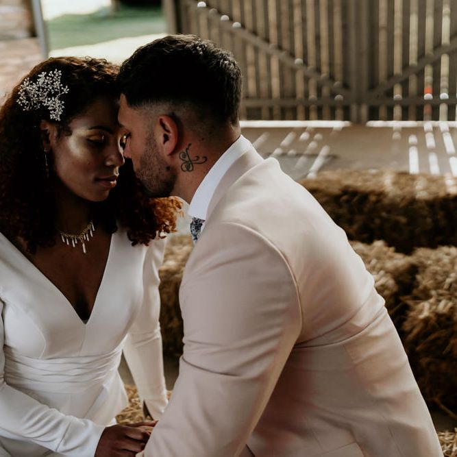 Black Bride with Afro Hair in Jumpsuit and Groom in Pink Blazer