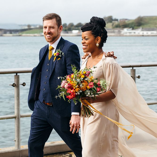 Black bride with braided top knot and wedding cape