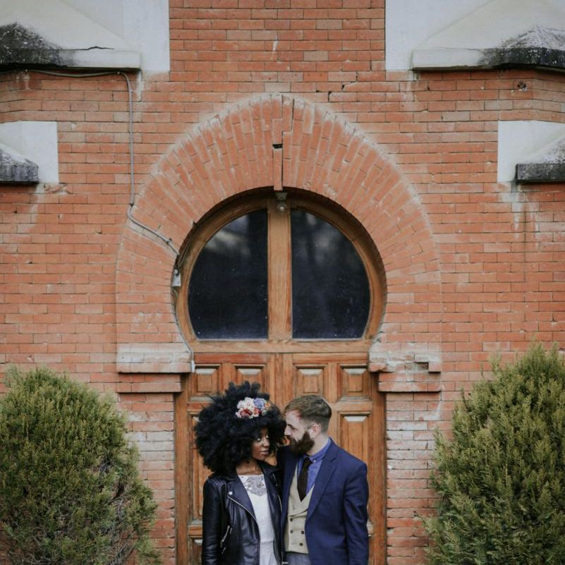 Stylish black bride with afro hair and leather jacket