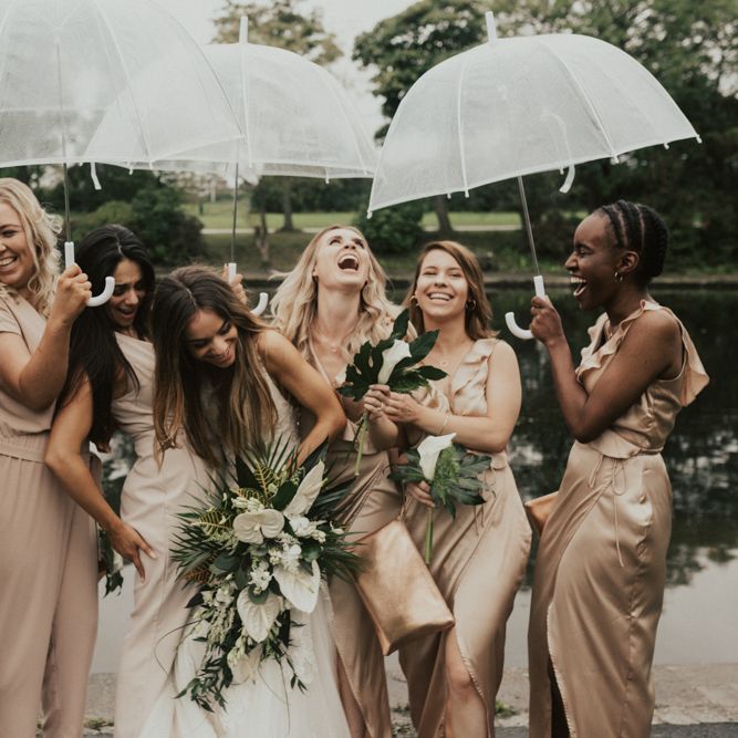Stylish bridal party portrait under umbrellas