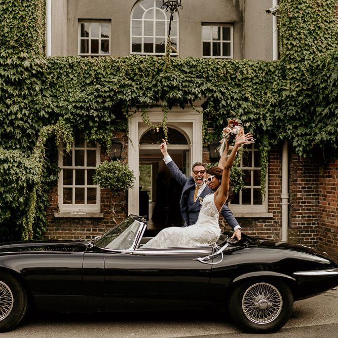 Nigerian bride in black e type Jaguar wedding car