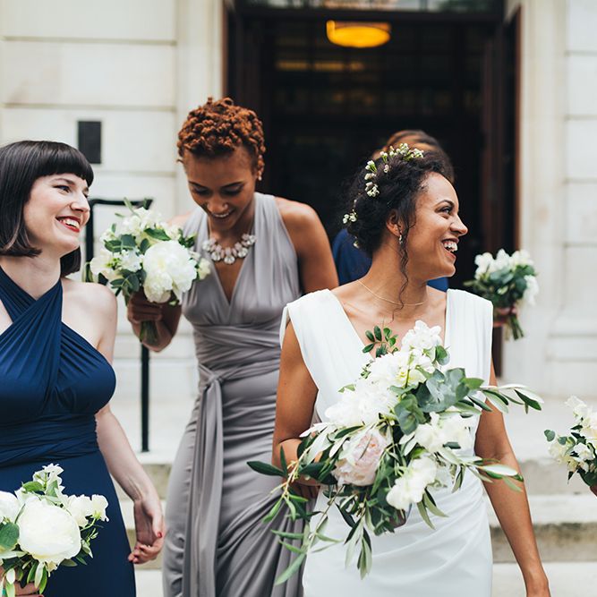 Black bride with flowers in her hair at city wedding