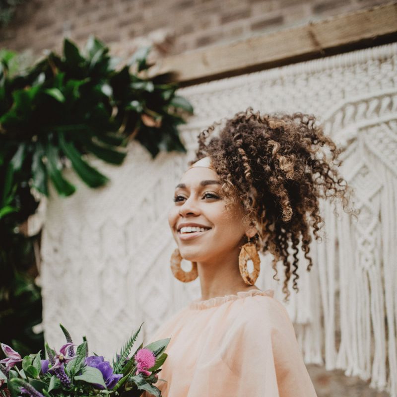 Black bride with curly hair tied in head scarf